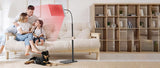  Family relaxing while using red light therapy panel in living room
