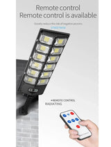 Remote control operating W789 Solar Light – user pointing at wall-mounted light