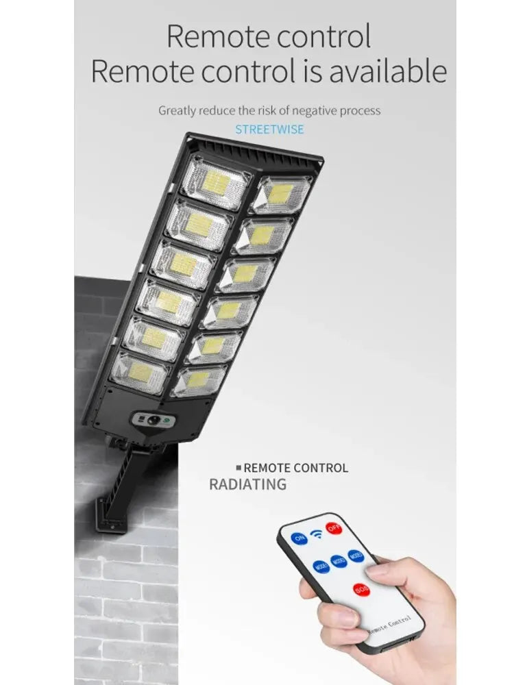 Remote control operating W789 Solar Light – user pointing at wall-mounted light