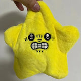  Hand squishing the top of the yellow angry star plush toy