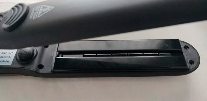  Close-up of flat iron steam plate showing nozzle and plate detail